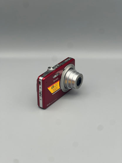 Red Kodak EasyShare M340 viewed from a front angle with its lens extended and side panel visible.