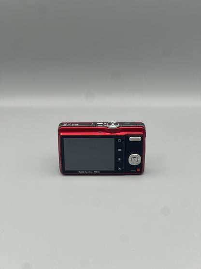 Red Kodak EasyShare M340 rear view showing the LCD screen and control buttons.