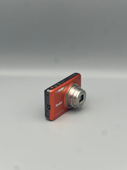 Angled front view of an orange Kodak EasyShare M5350 showing the extended lens and top controls