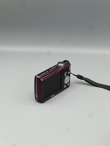 Angled rear view of a plum Nikon Coolpix S220 showing its LCD screen and wrist strap