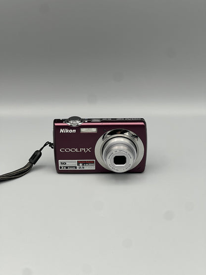 Front view of a plum Nikon Coolpix S220 with its silver lens extended