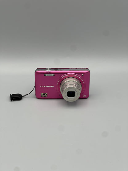 Front view of a pink Olympus VG-130 digital camera with its lens extended