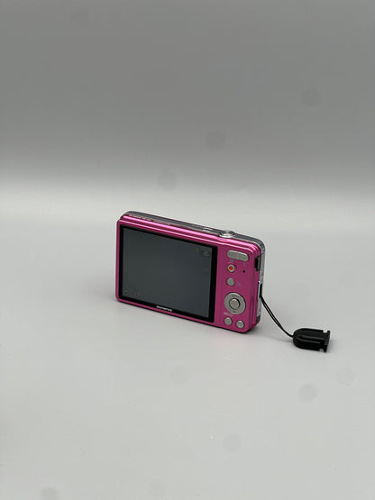 Angled rear view of a pink Olympus VG-130 showing the LCD screen and control panel