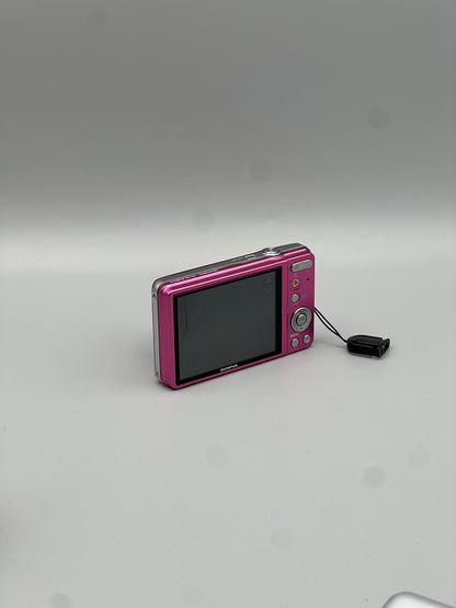 Rear and side view of a pink Olympus VG-130 showing the screen and top controls