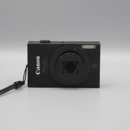 Black Canon PowerShot ELPH 520 HS front view with its lens extended and wrist strap attached.