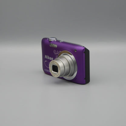 Front and side view of a purple Nikon Coolpix A100 with its lens extended