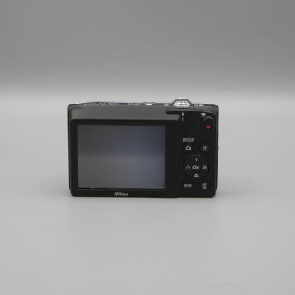 Rear view of a purple Nikon Coolpix A100 showing the LCD screen and control buttons