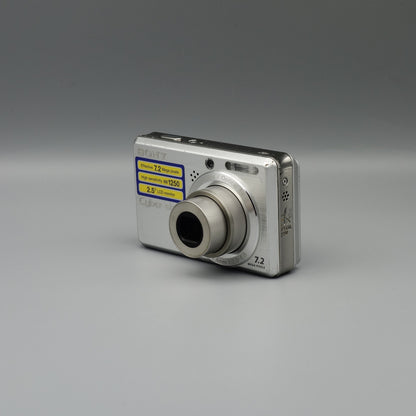 Silver Sony Cyber-shot DSC-S750 viewed from the opposite front corner with its lens extended
