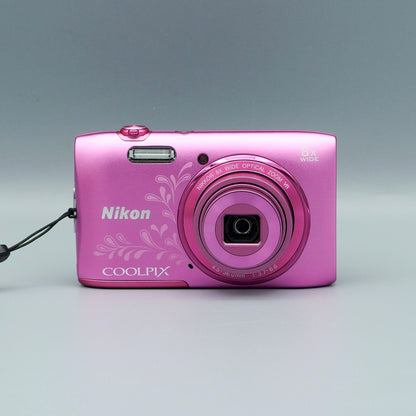 Front view of a pink floral Nikon Coolpix S3600 with its lens extended