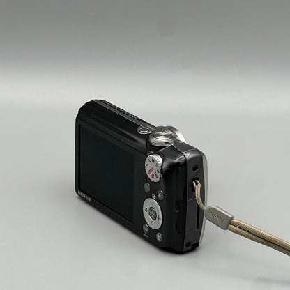 Rear and side view of a black Fujifilm FinePix F70EXR showing the screen, controls and wrist strap attachment