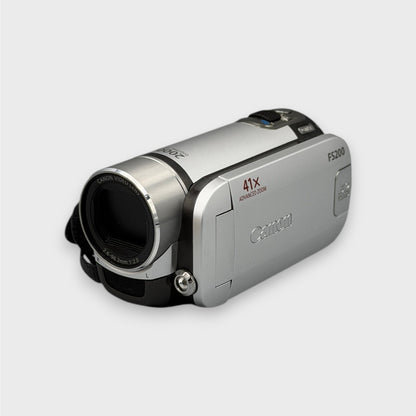 Angled front view of the silver Canon FS200 camcorder with its flip-out screen closed