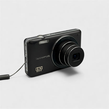 Angled front view of a black Olympus VG-120 showing its extended lens and silver side trim