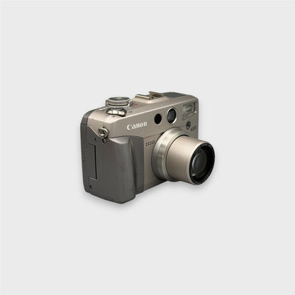 Silver Canon PowerShot G2 viewed from a front angle showing the extended lens and grip.