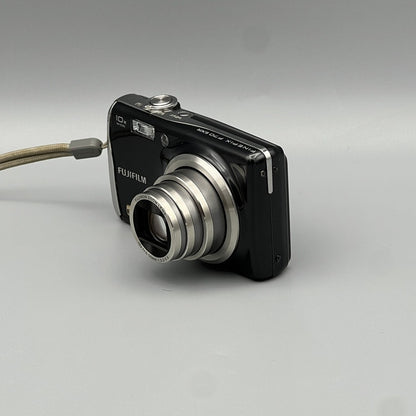 Front and side view of a black Fujifilm FinePix F70EXR with its silver lens barrel extended