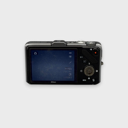 Rear view of a silver Nikon Coolpix S9300 showing the illuminated LCD screen and control buttons