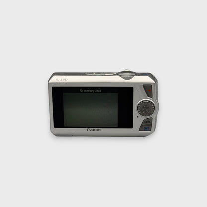 Rear view of a silver Canon PowerShot SD4500 IS showing the LCD screen and control buttons