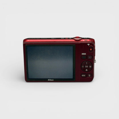 Red Nikon Coolpix S6500 rear view showing the LCD screen and control buttons.