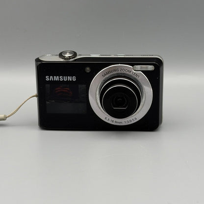 Front view of a black Samsung PL100 with its lens extended and front display visible