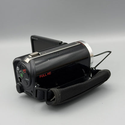 Side and rear view of the black Sanyo Xacti VPC-FH1 camcorder with hand strap and rear controls