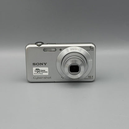 Silver Sony Cyber-shot DSC-W710 front view with its lens extended.