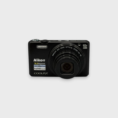 Front view of a black Nikon Coolpix S7000 with its lens extended