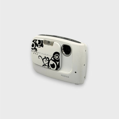 White Fujifilm FinePix Z30 with a black swirl pattern, viewed from a front angle showing the lens and side panel.
