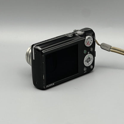 Angled rear view of a black Fujifilm FinePix F70EXR showing the LCD screen and silver controls
