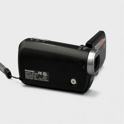 Side view of the black Panasonic SDR-S7P camcorder showing the model label and red record button