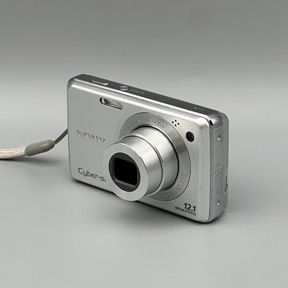 Silver Sony Cyber-shot DSC-W220 viewed from the opposite front corner with its lens extended