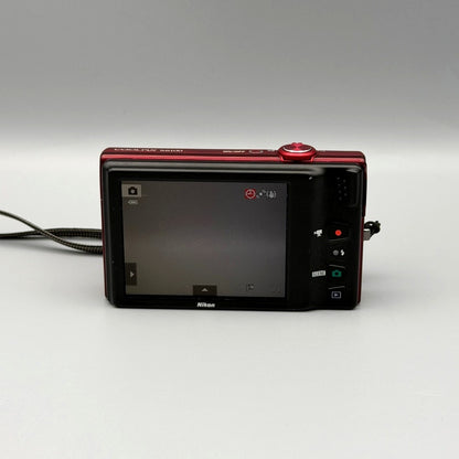 Nikon Coolpix S6100 rear view showing the LCD screen and control buttons.