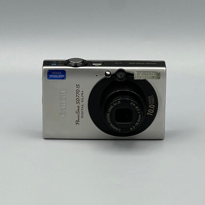 Front view of a silver Canon PowerShot SD770 IS with its black lens extended