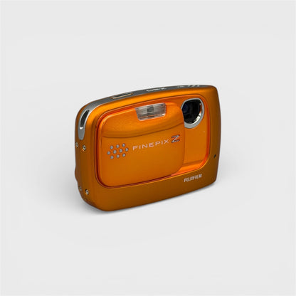 Orange Fujifilm FinePix Z30 viewed from a front angle with its sliding cover open, exposing the lens.