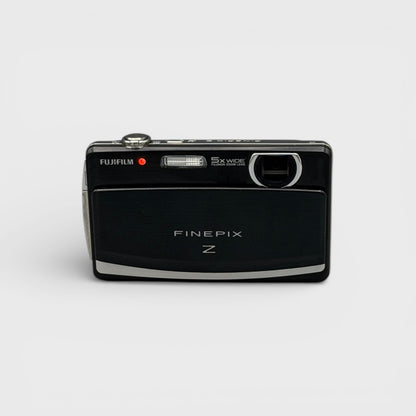 Front view of a black Fujifilm FinePix Z90 showing the exposed lens and flash