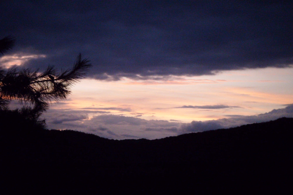 Peach sunset over dark mountain ridges